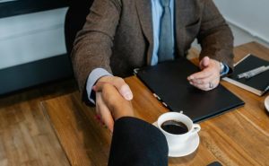 estate planning process, image of handshake at business meeting
