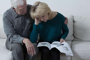 An older couple going through their finances looking distraught; Financial Planning Assistance Beaufort
