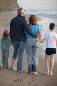 estate planning demystified, image of clothed family at the beach taken from behind