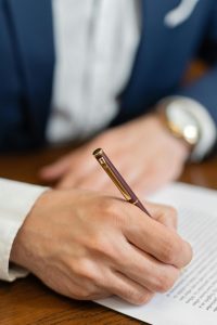 stop heirs from blowing their inheritance, image of hand signing a document