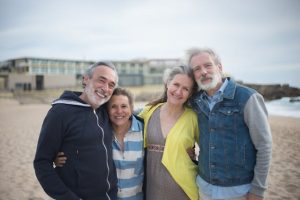 Medicaid trust, image of two middle-aged couples on a beach in jacket weather